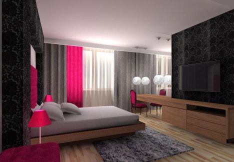 Projekt sypialni elementy różu - strefa TV z miejscami do przechowywania