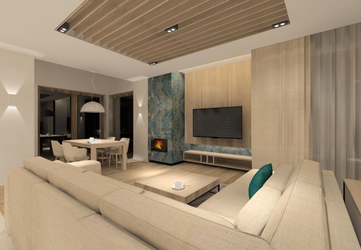 Przytulny salon z akcentami kolorystycznymi w kolorze zielono - niebieskim.