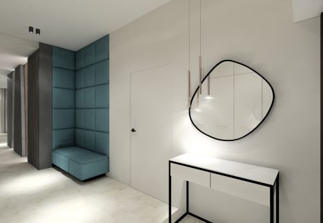 Zaraz po wejściu do domu, po prawej stronie znajduje się konsola z lustrem a dalej w głębi tapicerowane siedzisko z miękkimi panelami do sufitu.